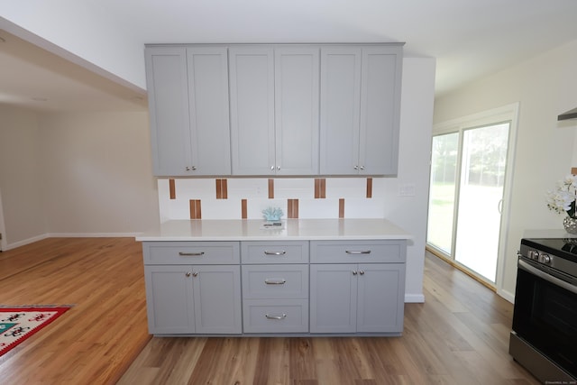 26 Riverdale Rd, Milford, CT 06460 - kitchen featuring stainless steel range, gray cabinetry, light wood-style floors, and light countertops