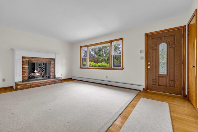 108 Sandelwood Dr, Madison, CT 06443 - foyer featuring baseboard heating, light wood-style flooring, and a fireplace