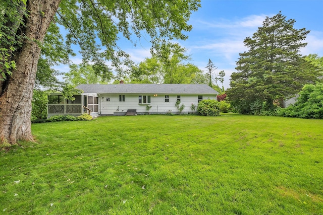 108 Sandelwood Dr, Madison, CT 06443 - back of property with a sunroom, a lawn, and a chimney