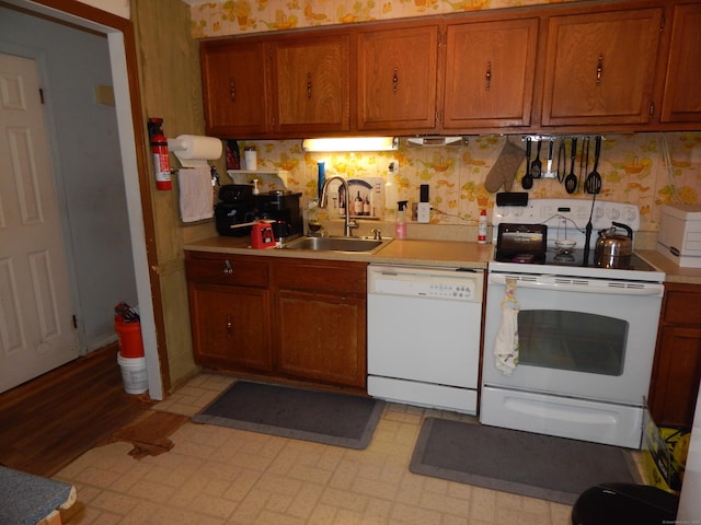 85 Bradford Rd, Torrington, CT 06790 - kitchen with white appliances, light countertops, brown cabinets, wallpapered walls, and decorative backsplash