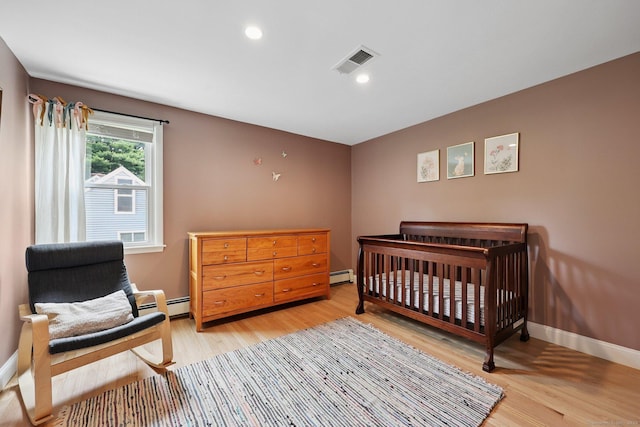 82 Shipman Dr, Glastonbury, CT 06033 - bedroom featuring light wood-style flooring, a baseboard heating unit, and recessed lighting