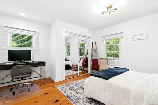 361 Danbury Rd, Ridgefield, CT 06877 - bedroom featuring a closet, wood finished floors, a desk, cooling unit, and a baseboard radiator