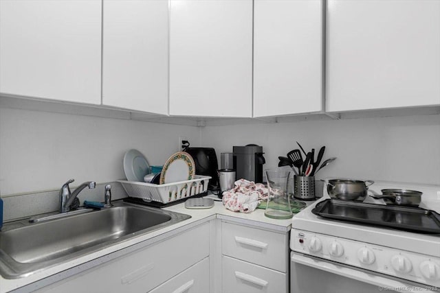 100 York St Unit 10R, New Haven, CT 06511 - kitchen featuring white range with electric cooktop, white cabinets, and light countertops