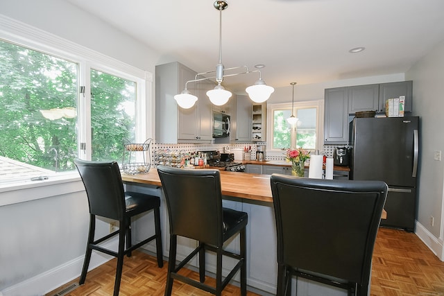 17 Adams St, Winchester, CT 06098 - kitchen with butcher block counters, appliances with stainless steel finishes, tasteful backsplash, gray cabinetry, and recessed lighting
