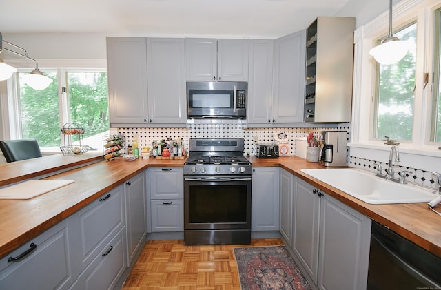 17 Adams St, Winchester, CT 06098 - kitchen with butcher block counters, stainless steel microwave, range with gas stovetop, gray cabinets, and dishwashing machine
