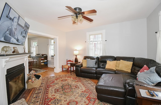 17 Adams St, Winchester, CT 06098 - living room with ceiling fan, a glass covered fireplace, and light wood-style flooring