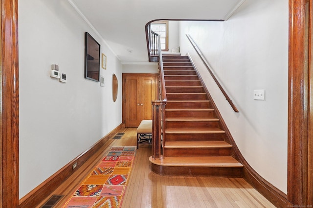 110 Westwood Rd, New Haven, CT 06515 - stairway with wood-type flooring, ornamental molding, and arched walkways
