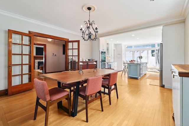 110 Westwood Rd, New Haven, CT 06515 - dining room featuring crown molding, a chandelier, light wood-style flooring, and recessed lighting