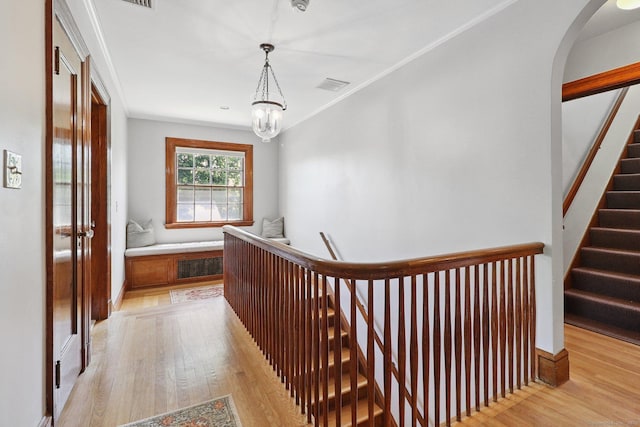 110 Westwood Rd, New Haven, CT 06515 - hall featuring light wood finished floors, a chandelier, arched walkways, and an upstairs landing