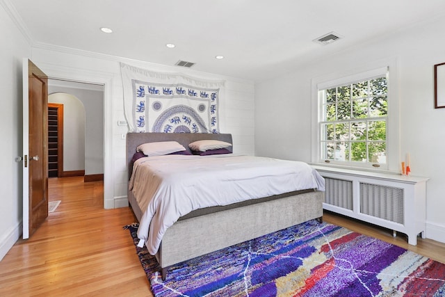 110 Westwood Rd, New Haven, CT 06515 - bedroom with ornamental molding, radiator, light wood finished floors, arched walkways, and recessed lighting