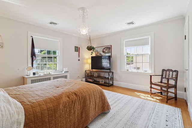 110 Westwood Rd, New Haven, CT 06515 - bedroom featuring radiator heating unit, ornamental molding, light wood-style flooring, and a chandelier