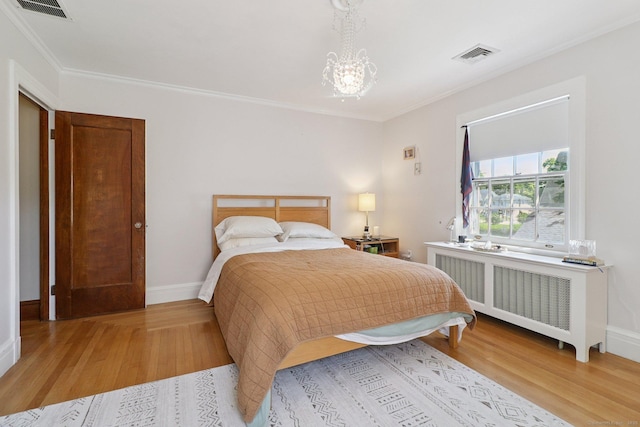 110 Westwood Rd, New Haven, CT 06515 - bedroom featuring radiator heating unit, light wood-style floors, crown molding, and a chandelier