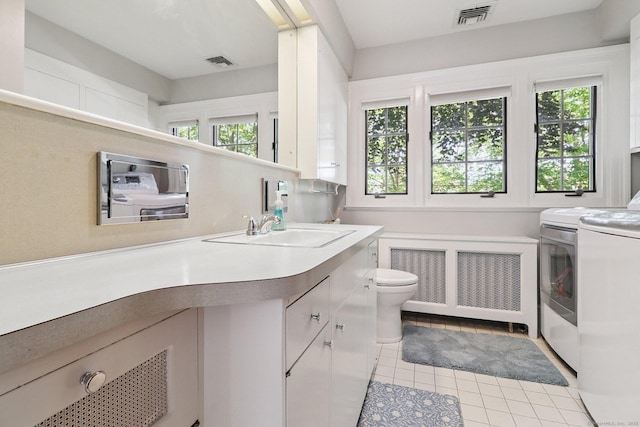 110 Westwood Rd, New Haven, CT 06515 - bathroom with radiator, washer and clothes dryer, vanity, and tile patterned floors