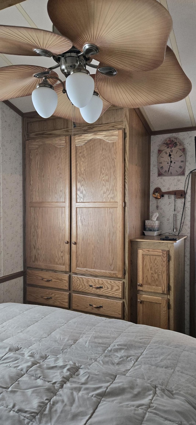 306 Old Colchester Rd Unit 197, Salem, CT 06420 - bedroom with wallpapered walls, ceiling fan, and wooden walls