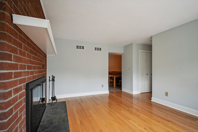 39 Wells Ave, Shelton, CT 06484 - unfurnished living room featuring a fireplace and light wood finished floors