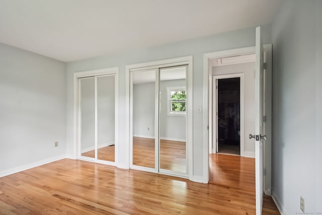 39 Wells Ave, Shelton, CT 06484 - unfurnished bedroom featuring two closets and light wood-style flooring