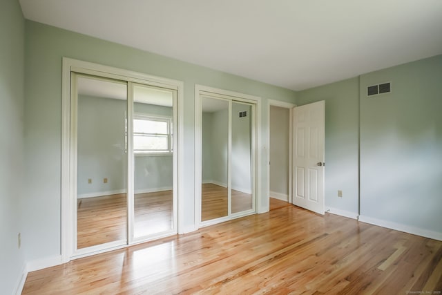 39 Wells Ave, Shelton, CT 06484 - unfurnished bedroom featuring multiple closets and light wood-type flooring