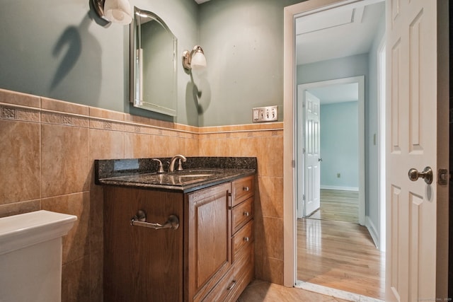 39 Wells Ave, Shelton, CT 06484 - bathroom with vanity, tile walls, a wainscoted wall, and wood finished floors