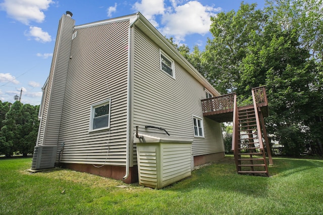39 Wells Ave, Shelton, CT 06484 - view of home's exterior featuring stairway, a chimney, a deck, and a lawn