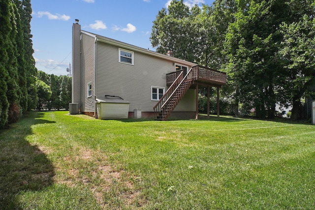39 Wells Ave, Shelton, CT 06484 - rear view of house featuring a chimney, stairs, a wooden deck, and a yard