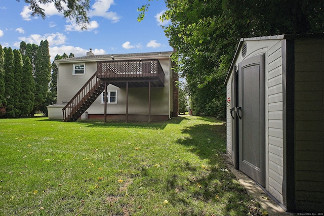 39 Wells Ave, Shelton, CT 06484 - back of property featuring stairway, a yard, a deck, and a storage unit