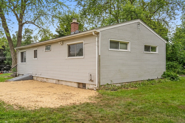 47 Charter Rd, Ellington, CT 06029 - view of property exterior with a chimney and a lawn