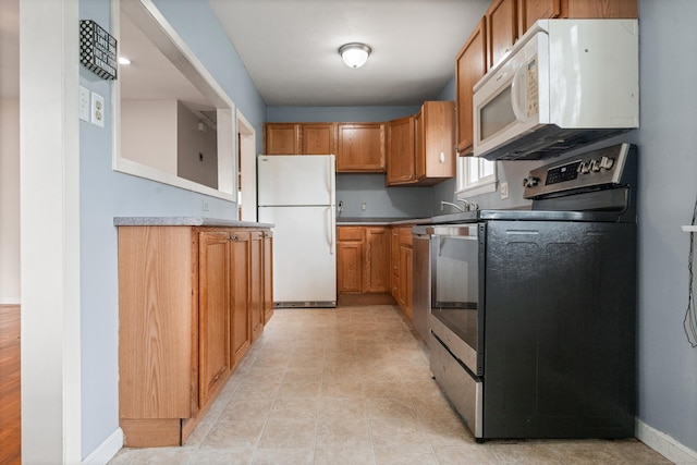 47 Charter Rd, Ellington, CT 06029 - kitchen with white appliances and brown cabinets