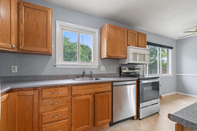 47 Charter Rd, Ellington, CT 06029 - kitchen with stainless steel appliances, brown cabinetry, and a ceiling fan