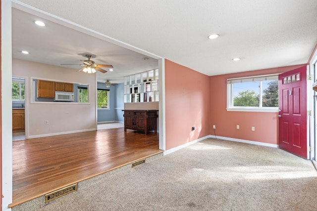47 Charter Rd, Ellington, CT 06029 - unfurnished living room with carpet floors, a ceiling fan, recessed lighting, and wood finished floors