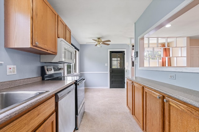 47 Charter Rd, Ellington, CT 06029 - kitchen with stainless steel appliances, ceiling fan, brown cabinets, and light tile patterned floors