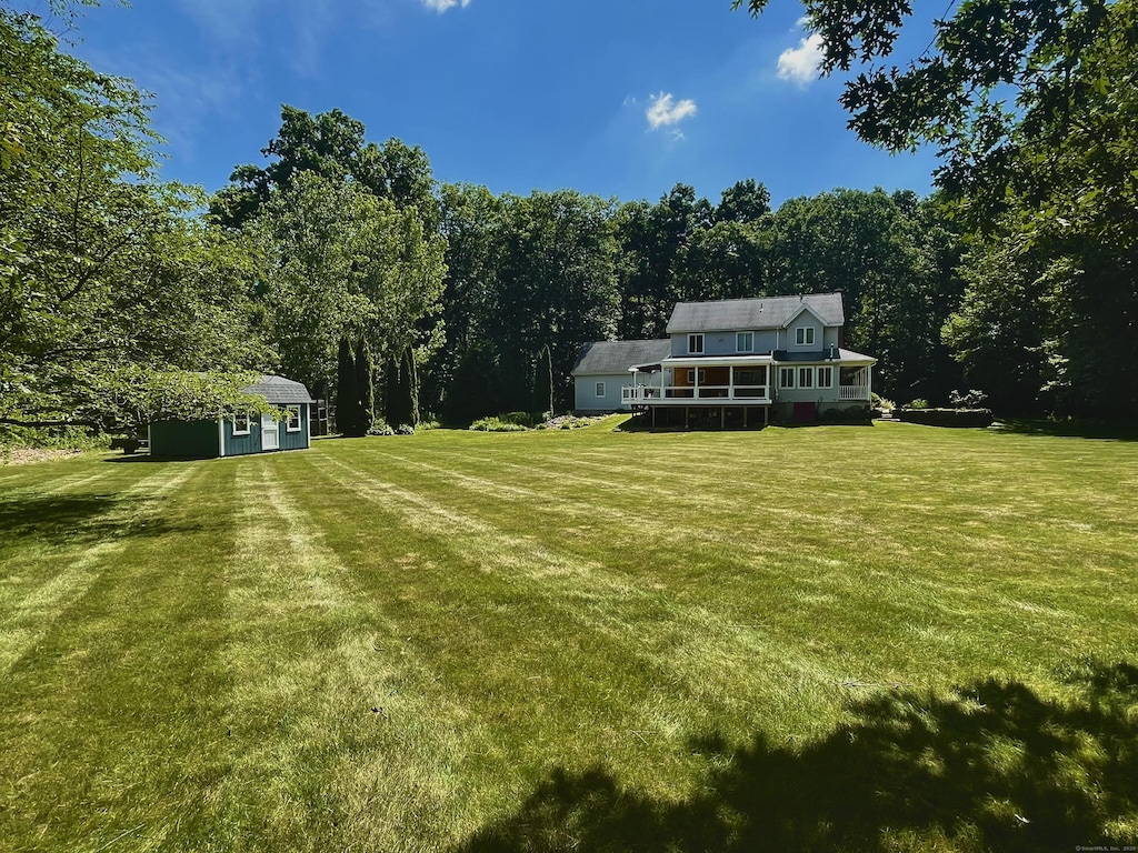8 Brendans Way, Granby, CT 06035 - view of green lawn with an outbuilding and a wooded view