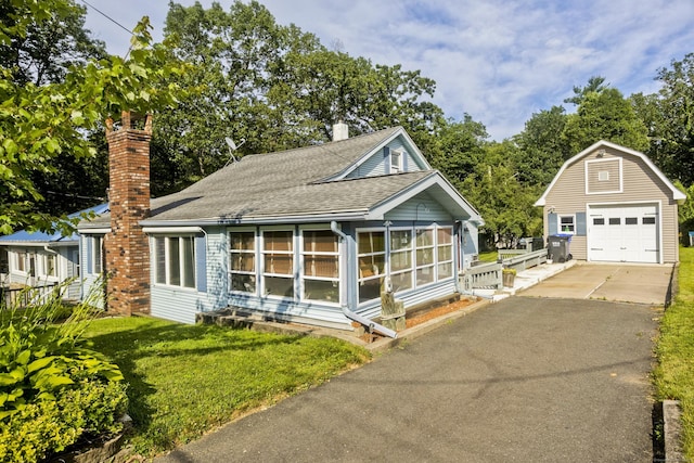 282 Halladay Dr, Suffield, CT 06093 - view of front facade featuring an outdoor structure, roof with shingles, a detached garage, driveway, and a chimney