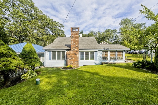 282 Halladay Dr, Suffield, CT 06093 - back of house with a chimney, a yard, and a sunroom