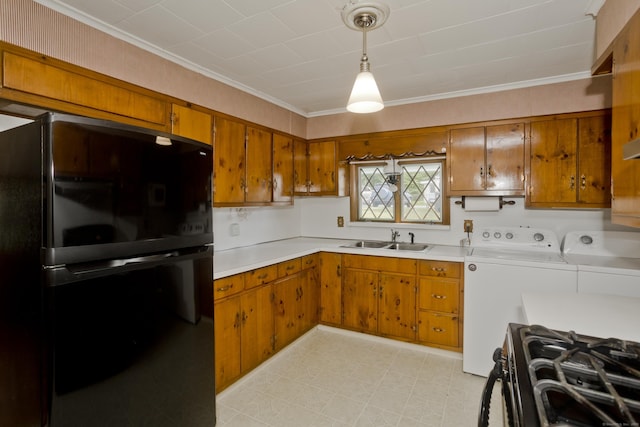 282 Halladay Dr, Suffield, CT 06093 - kitchen with freestanding refrigerator, washer and dryer, brown cabinets, light countertops, and range with gas stovetop