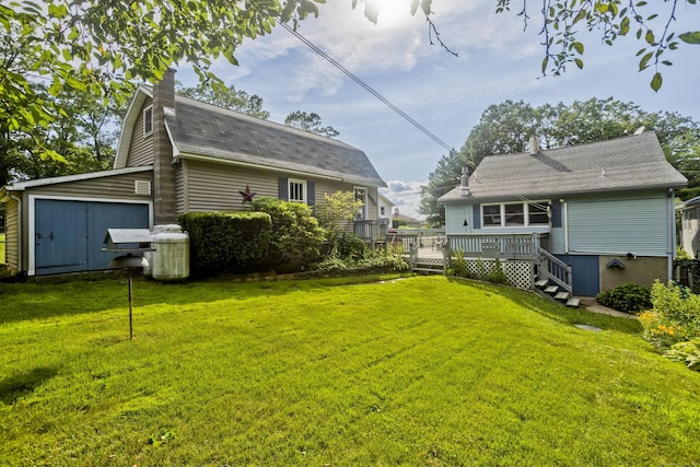 282 Halladay Dr, Suffield, CT 06093 - rear view of house with a deck, a chimney, roof with shingles, and a lawn