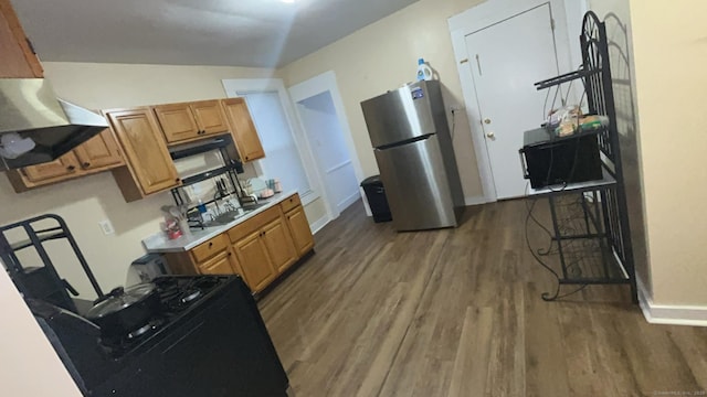 115 Lloyd St, New Haven, CT 06513 - kitchen with freestanding refrigerator, wood finished floors, light countertops, black range with gas cooktop, and extractor fan