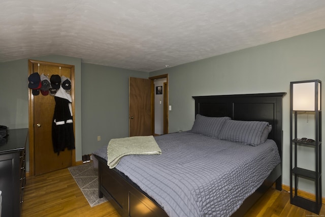 26 Sandpiper Rd, Enfield, CT 06082 - bedroom with wood finished floors, vaulted ceiling, and a textured ceiling