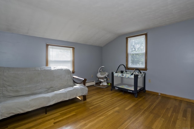 26 Sandpiper Rd, Enfield, CT 06082 - living area featuring lofted ceiling, a baseboard heating unit, and wood finished floors