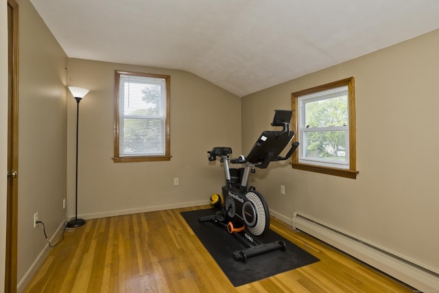 26 Sandpiper Rd, Enfield, CT 06082 - workout room with a baseboard radiator, vaulted ceiling, wood finished floors, and healthy amount of natural light