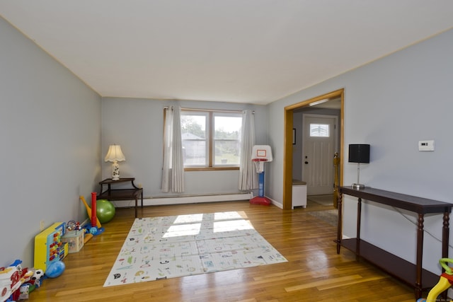 26 Sandpiper Rd, Enfield, CT 06082 - playroom with a baseboard heating unit and wood finished floors