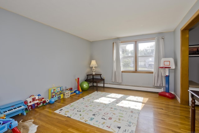26 Sandpiper Rd, Enfield, CT 06082 - rec room featuring a baseboard heating unit and wood finished floors
