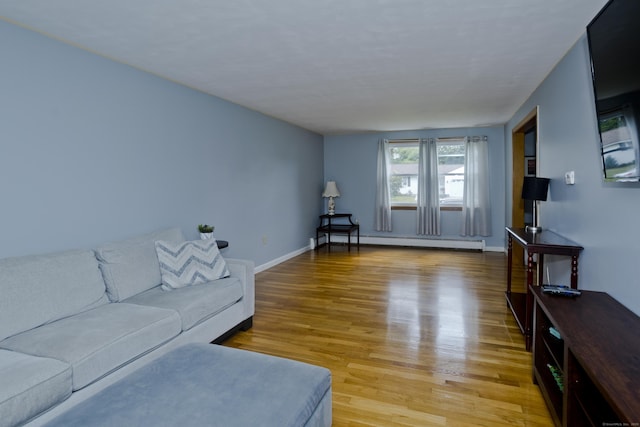 26 Sandpiper Rd, Enfield, CT 06082 - living room featuring a baseboard heating unit and light wood-type flooring