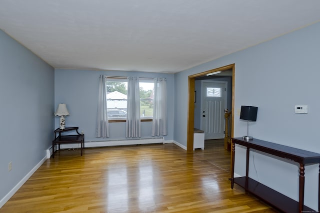 26 Sandpiper Rd, Enfield, CT 06082 - foyer with a baseboard heating unit and light wood-style flooring