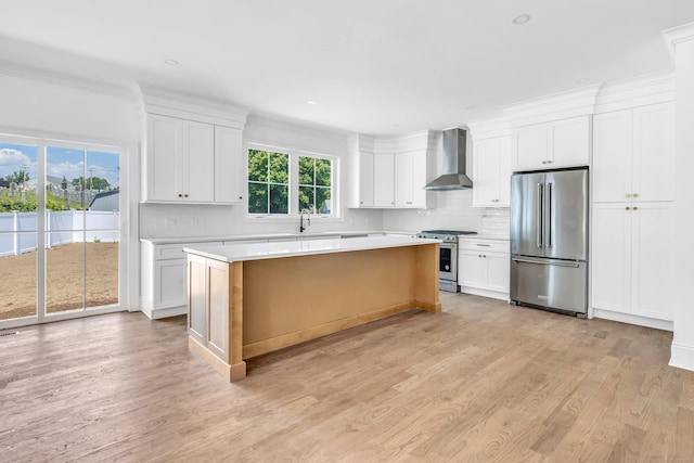 LotA Roseville Street, Fairfield, CT 06825 - kitchen featuring appliances with stainless steel finishes, wall chimney range hood, decorative backsplash, light countertops, and ornamental molding