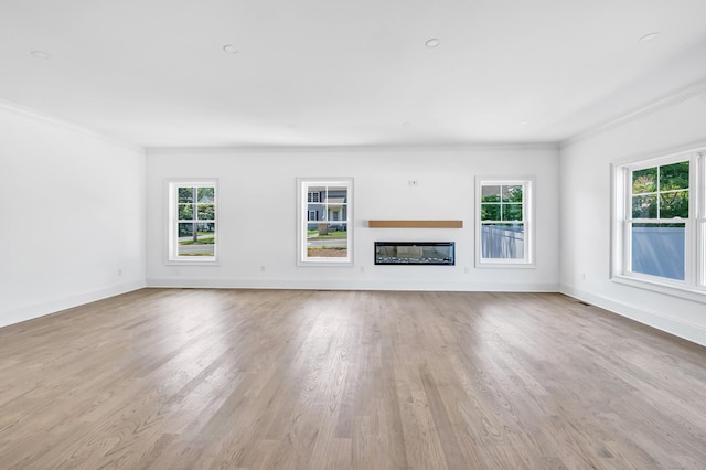 LotA Roseville Street, Fairfield, CT 06825 - unfurnished living room featuring ornamental molding, healthy amount of natural light, wood finished floors, and a glass covered fireplace