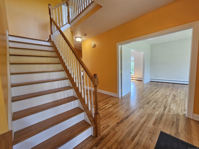 41 Mesa Dr, Bethany, CT 06524 - stairway with a baseboard heating unit and wood finished floors