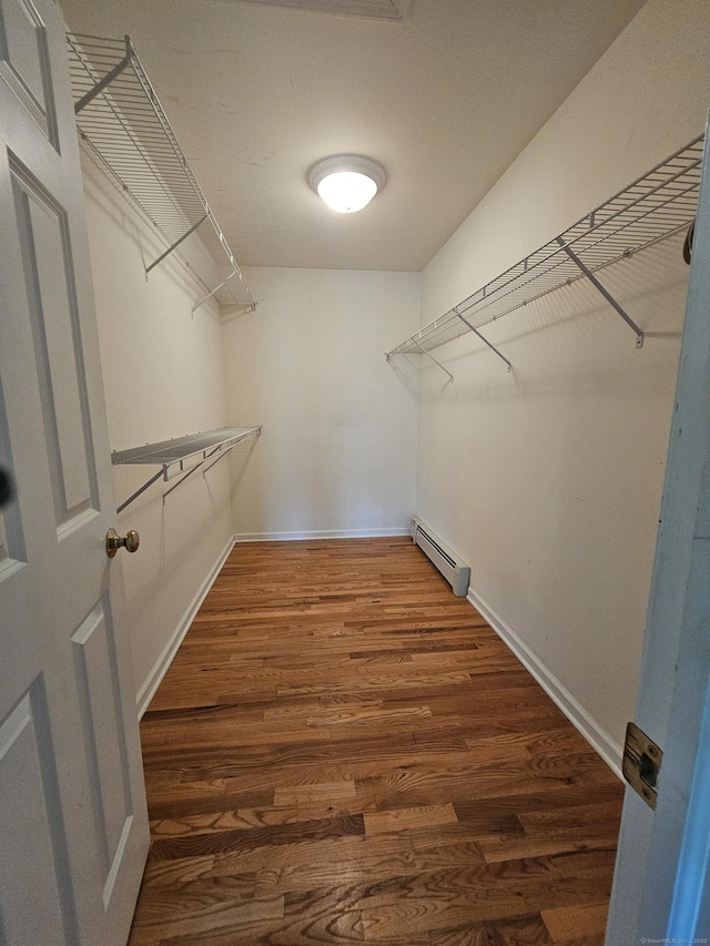 41 Mesa Dr, Bethany, CT 06524 - spacious closet featuring a baseboard heating unit and wood finished floors