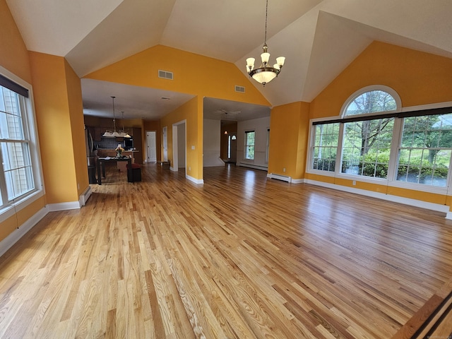 41 Mesa Dr, Bethany, CT 06524 - unfurnished living room with a chandelier, light wood-type flooring, a baseboard heating unit, and high vaulted ceiling