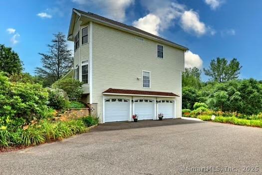 41 Mesa Dr, Bethany, CT 06524 - view of side of property featuring a garage and driveway