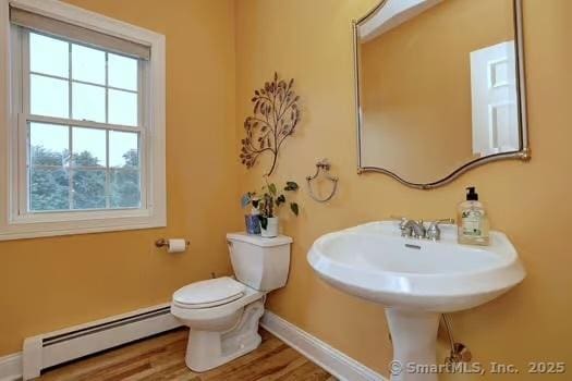 41 Mesa Dr, Bethany, CT 06524 - half bathroom with a baseboard radiator and wood finished floors